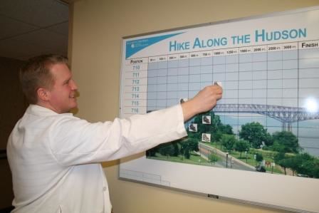 Man pointing to a graph about a Hike Along the Hudson